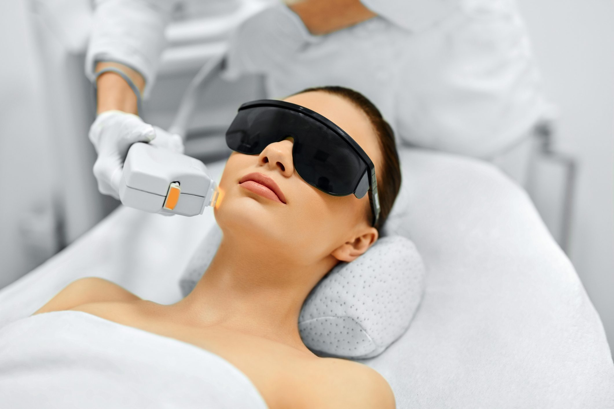 Skin Care. Young Woman Receiving Facial Beauty Treatment, Removing Pigmentation At Cosmetic Clinic. Intense Pulsed Light Therapy. IPL. Rejuvenation, Photo Facial Therapy. Anti-aging Procedures.