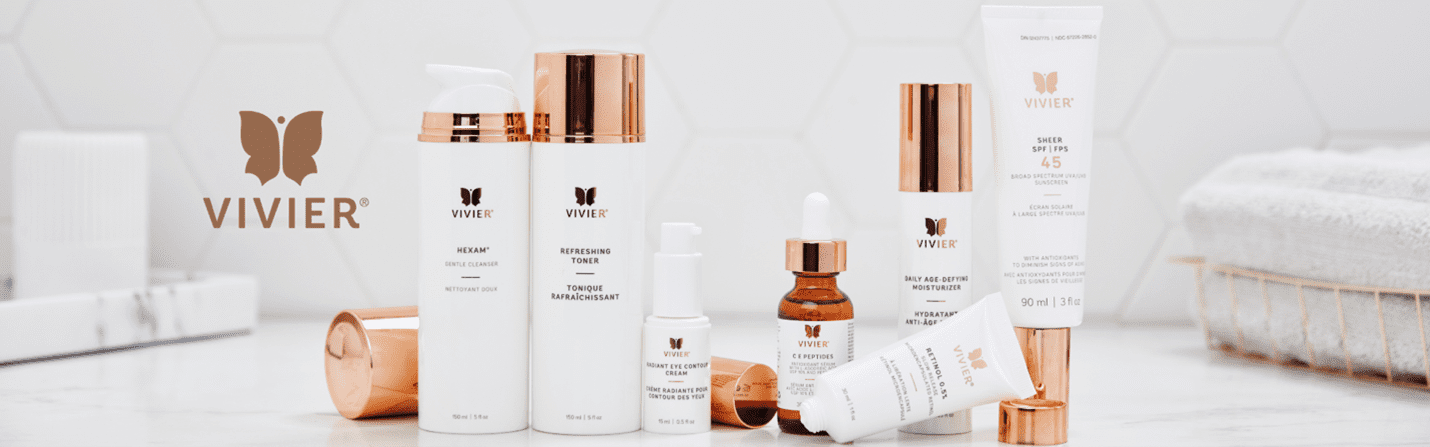 Elegant skincare bottles with rose gold accents on a white surface.