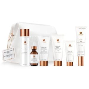 A set of skincare products with white and rose gold packaging.