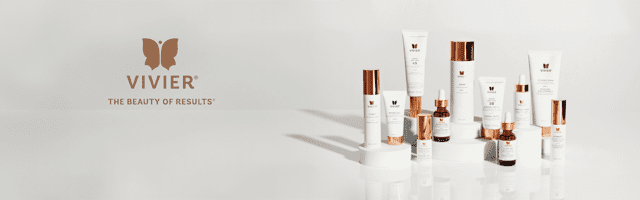 Three skincare products with white and rose gold packaging on a white surface.